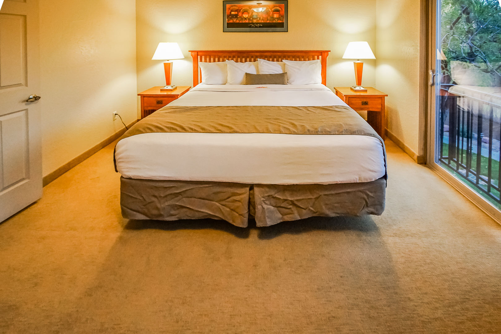 A master bedroom with a balcony at VRI's Villas of Sedona in Arizona.